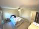 Bedroom with carpeted floor, ceiling fan, and access to hallway bathroom at 5211 Nicodemus Dr, Plainfield, IN 46168