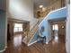 Spacious foyer featuring hardwood floors and a staircase leading to the upper level at 5211 Nicodemus Dr, Plainfield, IN 46168