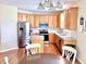 Updated kitchen with stainless appliances, granite counters, and a center island, perfect for cooking and entertaining at 5211 Nicodemus Dr, Plainfield, IN 46168