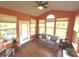 Bright sunroom featuring hardwood floors, natural light, and a comfortable striped sofa for relaxing at 5211 Nicodemus Dr, Plainfield, IN 46168