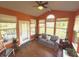 Bright sunroom features hardwood floors, ample windows, and comfortable seating at 5211 Nicodemus Dr, Plainfield, IN 46168