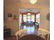 View of sunroom from kitchen, showcasing hardwood floors and natural light at 5211 Nicodemus Dr, Plainfield, IN 46168