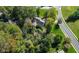 Aerial view of a home nestled among lush, mature trees in a quiet neighborhood at 1612 S Jeanne Ct, New Palestine, IN 46163
