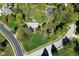Aerial view of a home surrounded by lush trees and greenery in a suburban neighborhood on a quiet street at 1612 S Jeanne Ct, New Palestine, IN 46163