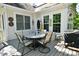 Cozy back deck with a dining area, offering a delightful outdoor experience and a seamless connection with nature at 1612 S Jeanne Ct, New Palestine, IN 46163