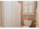 Bathroom featuring a toilet, shower and plantation shutters at 1612 S Jeanne Ct, New Palestine, IN 46163