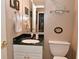 Traditional bathroom featuring marble countertops, white vanity, decorative wallpaper, and vintage fixtures at 1612 S Jeanne Ct, New Palestine, IN 46163