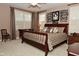 Inviting bedroom with a dark wood bed frame, shuttered windows, and decorative wall art at 1612 S Jeanne Ct, New Palestine, IN 46163