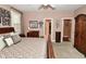 Bedroom with dark wood trim, shuttered windows, and view into other rooms at 1612 S Jeanne Ct, New Palestine, IN 46163