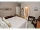 Comfortable bedroom featuring light pink walls, light carpet, and decorative wall art at 1612 S Jeanne Ct, New Palestine, IN 46163