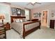 Inviting bedroom with a dark wood bed frame, shuttered windows, decorative wall art, and an en suite bathroom at 1612 S Jeanne Ct, New Palestine, IN 46163