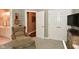 Bedroom featuring a closet, chair, ottoman, TV, and adjoining bathroom at 1612 S Jeanne Ct, New Palestine, IN 46163