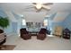 This spacious bonus room features soft carpeting, a ceiling fan and natural light at 1612 S Jeanne Ct, New Palestine, IN 46163