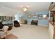 Large bonus room provides ample space for seating and relaxation, with plush carpeting at 1612 S Jeanne Ct, New Palestine, IN 46163