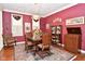 Cozy dining room featuring red walls, hardwood floors, and beautiful decor at 1612 S Jeanne Ct, New Palestine, IN 46163