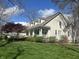 Charming home with a well-manicured lawn, landscaped yard and a welcoming front porch with white columns at 1612 S Jeanne Ct, New Palestine, IN 46163
