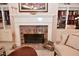 Elegant fireplace with brick surround, built-in shelving and decor at 1612 S Jeanne Ct, New Palestine, IN 46163