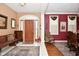 Inviting foyer featuring a wooden front door, tile flooring and natural light at 1612 S Jeanne Ct, New Palestine, IN 46163