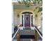 Charming front door with an arched window, flanked by elegant lanterns and seasonal decor at 1612 S Jeanne Ct, New Palestine, IN 46163