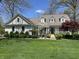 Charming home featuring a meticulously landscaped front yard, quaint wooden walkway, and beautiful trees in a suburban setting at 1612 S Jeanne Ct, New Palestine, IN 46163