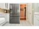 Spacious kitchen features stainless steel refrigerator, white cabinets, and tiled flooring at 1612 S Jeanne Ct, New Palestine, IN 46163
