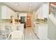 Bright and modern kitchen featuring white cabinets, granite countertops, and stainless steel appliances at 1612 S Jeanne Ct, New Palestine, IN 46163