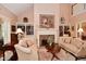 Elegant living room with fireplace, built-in bookshelves, and comfortable seating at 1612 S Jeanne Ct, New Palestine, IN 46163