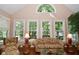 Bright and airy living room featuring large windows, hardwood floors, and stylish furnishings at 1612 S Jeanne Ct, New Palestine, IN 46163