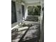 Relaxing front porch featuring a hanging swing, a bench, and views of the lush surroundings for tranquil outdoor living at 1612 S Jeanne Ct, New Palestine, IN 46163
