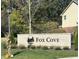 Community entrance sign for Fox Cove, with well-maintained landscaping and a decorative pumpkin at 1612 S Jeanne Ct, New Palestine, IN 46163