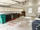 Spacious garage with storage cabinets, two windows and Craftsman garage door opener at 7722 Shady Hills W Dr, Indianapolis, IN 46278