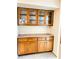 Butler's pantry featuring built-in cabinets with glass door accents at 7722 Shady Hills W Dr, Indianapolis, IN 46278