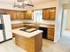 Kitchen featuring a central island with cooktop and oak cabinets at 7722 Shady Hills W Dr, Indianapolis, IN 46278