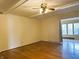 Living room showcasing hardwood floors and a ceiling fan at 7722 Shady Hills W Dr, Indianapolis, IN 46278