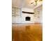 Living room showcasing hardwood floors and a painted fireplace with built-ins at 7722 Shady Hills W Dr, Indianapolis, IN 46278