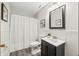 Neutral bathroom featuring a vanity, toilet, mirror, and a shower with a white shower curtain at 610 E Morgan St, Martinsville, IN 46151