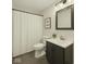 Compact bathroom featuring a shower with curtain, vanity with storage, and dark floors and finishes at 610 E Morgan St, Martinsville, IN 46151