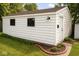 Detached one-car garage with white siding, black trim, and landscaping for a functional and aesthetically pleasing addition at 610 E Morgan St, Martinsville, IN 46151