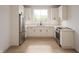 Bright kitchen featuring white cabinets, stainless steel appliances, and a large window at 610 E Morgan St, Martinsville, IN 46151
