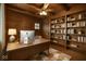 Home office with wood-paneled walls, built-in bookshelves, and a spacious desk for a productive work environment at 610 E Morgan St, Martinsville, IN 46151