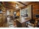 Charming home office with wood paneling, a ceiling fan and ample light from the window at 610 E Morgan St, Martinsville, IN 46151