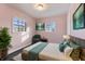 Bedroom with pink walls, dark hardwood floors, and teal accents at 2103 Danbury Dr, Indianapolis, IN 46231