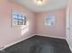 Empty bedroom with pink walls and dark hardwood floors at 2103 Danbury Dr, Indianapolis, IN 46231