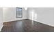 Simple bedroom with dark hardwood floors and a window at 2103 Danbury Dr, Indianapolis, IN 46231