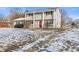 Two-story house with a red door and snow-covered lawn at 2103 Danbury Dr, Indianapolis, IN 46231