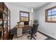 Bright home office features built-in shelving and a large desk at 2103 Danbury Dr, Indianapolis, IN 46231
