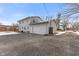Rear view of house, detached garage and driveway at 2103 Danbury Dr, Indianapolis, IN 46231