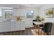 Eat-in kitchen with white shaker cabinets and modern light fixture at 2103 Danbury Dr, Indianapolis, IN 46231