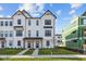 Charming new construction townhome with a white exterior, dark trim, and a well-manicured lawn at 4191 Barrel Ln, Westfield, IN 46062