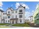 Beautiful white modern farmhouse with dark trim, lush green lawn and inviting entryway at 4191 Barrel Ln, Westfield, IN 46062